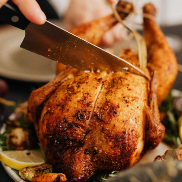 knife cutting into a cooked turkey